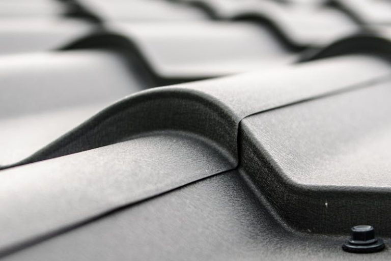 Close-up view of a metal roof's wavy design showcasing rivets and structural detail.